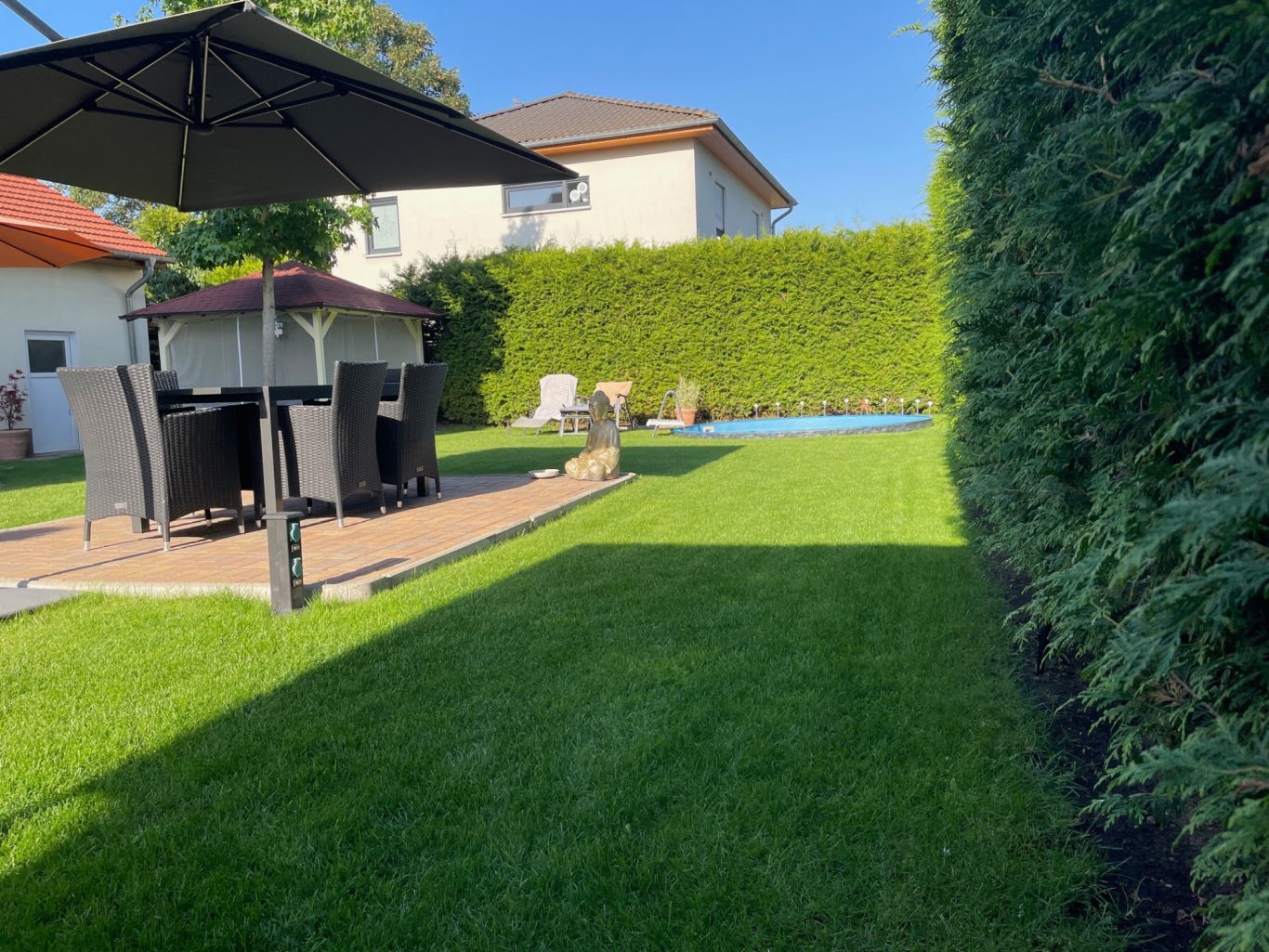 Nachher: Eine gepflegte Gartenanlage mit saftigem Rasen und harmonischem Ambiente. Nachher: Gepflegter Garten mit schönem Rasen